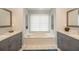 Bathroom featuring a soaking tub, tiled flooring and double vanity with granite countertops at 1205 Trey Ct, Marietta, GA 30064