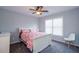 Bedroom features a ceiling fan, window with blinds, and patterned bedding at 1205 Trey Ct, Marietta, GA 30064