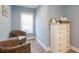 Charming bedroom with wicker chairs, dresser and soft, natural light at 1205 Trey Ct, Marietta, GA 30064