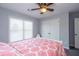 Bedroom features a ceiling fan, closet, window, and patterned bedding at 1205 Trey Ct, Marietta, GA 30064