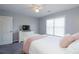 Neutral bedroom features a bed with plush pillows, a dresser, and a large window for natural light at 1205 Trey Ct, Marietta, GA 30064