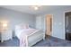 Cozy bedroom with carpet, neutral paint, and a large window providing natural light at 1205 Trey Ct, Marietta, GA 30064