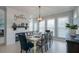 Bright dining room features a modern light fixture and large windows that let in natural light at 1205 Trey Ct, Marietta, GA 30064