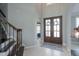 Elegant entryway with a staircase, chandelier, and a view into the living room at 1205 Trey Ct, Marietta, GA 30064