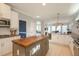 Bright kitchen with an island and bar seating, offering a view into the dining and living areas at 1205 Trey Ct, Marietta, GA 30064