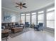 Sun-filled living room featuring a leather sofa, accent chairs, and large windows at 1205 Trey Ct, Marietta, GA 30064