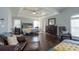 Spacious main bedroom with hardwood flooring and a tray ceiling, featuring leather furniture at 1205 Trey Ct, Marietta, GA 30064