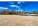 Scenic pond view with fountain under a bright blue sky with clouds at 1205 Trey Ct, Marietta, GA 30064