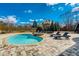 A private backyard pool is surrounded by a stone patio, lush landscaping, and lounge chairs at 1205 Trey Ct, Marietta, GA 30064