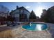 A private backyard with a pool, a stone patio with lounge chairs and green landscaping at 1205 Trey Ct, Marietta, GA 30064