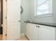 Powder room featuring a storage cabinet and a window for natural lighting at 1205 Trey Ct, Marietta, GA 30064