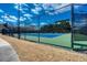 Exterior view of a community tennis court enclosed by a high fence for recreational sports at 1205 Trey Ct, Marietta, GA 30064