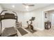 Bright workout room features light wood floors, a treadmill, an exercise bike, and natural light at 1205 Trey Ct, Marietta, GA 30064