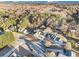 Aerial view of a neighborhood with mature trees, well-manicured lawns, and multiple homes on a quiet street at 128 Graybrook Ct, Grayson, GA 30017