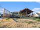 View of the backyard and covered patio, showing the outdoor entertaining area and expansive green space at 128 Graybrook Ct, Grayson, GA 30017