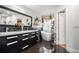 Modern bathroom featuring a soaker tub, dual sinks, and stylish black cabinetry at 128 Graybrook Ct, Grayson, GA 30017