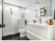 Modern bathroom with white tile, glass shower, sleek vanity and contemporary fixtures at 128 Graybrook Ct, Grayson, GA 30017