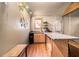 A kitchenette area has wood cabinets and a view through a glass paneled wall to an upper level at 128 Graybrook Ct, Grayson, GA 30017