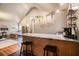 A kitchenette with dark bar stools has a clear view of a sleeping and sitting area at 128 Graybrook Ct, Grayson, GA 30017