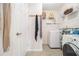 Efficient laundry area featuring modern washer and dryer, shelving, and ample storage space at 128 Graybrook Ct, Grayson, GA 30017