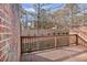 Private back porch surrounded by brick walls and a brown railing at 1690 Mosaic Way, Smyrna, GA 30080