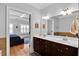 Bathroom with double vanity, wood cabinets, white countertop, and view of the bedroom at 1690 Mosaic Way, Smyrna, GA 30080