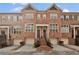 Charming brick townhouse featuring a private garage and entryway with decorative staircase at 1690 Mosaic Way, Smyrna, GA 30080