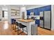 Modern kitchen featuring blue cabinets, stainless steel appliances, and a wood-top island at 1690 Mosaic Way, Smyrna, GA 30080