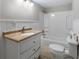 Bright bathroom featuring a tub/shower combo and vanity with tile countertop at 19 Roving Rd, Cartersville, GA 30121