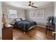 Bedroom with hardwood floors, neutral colored walls and trim, a ceiling fan, and bright windows at 19 Roving Rd, Cartersville, GA 30121