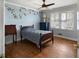 Childs bedroom with hardwood floors, a ceiling fan, and monkey-themed wall decorations at 19 Roving Rd, Cartersville, GA 30121