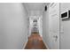 Hallway with hardwood floors, neutral paint and baseboard trim, and access to many rooms at 19 Roving Rd, Cartersville, GA 30121