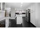 Bright kitchen with stainless steel appliances, a white island, and elegant dark hexagon tile floors at 19 Roving Rd, Cartersville, GA 30121