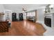 Large living room with hardwood floors, a fireplace, and bright window shutters offering plenty of natural light at 19 Roving Rd, Cartersville, GA 30121