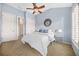 Bedroom with blue walls, ceiling fan, and white bedding at 2102 Monhegan Se Way # 2102, Smyrna, GA 30080