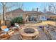 Backyard featuring a stone fire pit, patio, and comfortable outdoor seating with a landscaped yard at 8720 Rhapsody Ln, Cumming, GA 30041