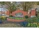 A brick sign welcomes residents to Glencrest Park with colorful flowers and manicured landscaping at 1331 Penhurst Dr, Lawrenceville, GA 30043