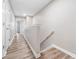 Hallway featuring neutral walls, wood look flooring, and multiple closets at 1331 Penhurst Dr, Lawrenceville, GA 30043