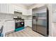 Kitchen featuring stainless steel appliances, stylish tile backsplash, and ample cabinet space at 1331 Penhurst Dr, Lawrenceville, GA 30043