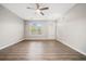 Bright living room with ceiling fan and a view of the front yard through large windows at 1331 Penhurst Dr, Lawrenceville, GA 30043