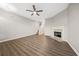 Bright living room features a ceiling fan, fireplace, and staircase at 1331 Penhurst Dr, Lawrenceville, GA 30043