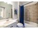 A well-lit bathroom features a shower with tan tiles, a toilet and vanity at 134 Turman Se Ave, Atlanta, GA 30315