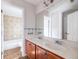 Bathroom featuring a double sink vanity with access to a shower and bathtub at 134 Turman Se Ave, Atlanta, GA 30315