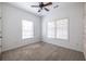 A bright bedroom features neutral carpet, two windows with blinds, and a ceiling fan at 134 Turman Se Ave, Atlanta, GA 30315