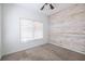 This bedroom features neutral carpet, a wood accent wall and a window with blinds at 134 Turman Se Ave, Atlanta, GA 30315