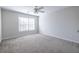 A simple bedroom with a window, carpeted floor, and neutral paint at 134 Turman Se Ave, Atlanta, GA 30315