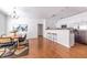 Open-concept dining area with a modern chandelier, white cabinets and stainless steel appliances at 134 Turman Se Ave, Atlanta, GA 30315