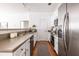 Well-lit kitchen featuring white cabinets, stainless appliances, and a breakfast bar at 134 Turman Se Ave, Atlanta, GA 30315