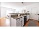 Open kitchen featuring white cabinets, stainless appliances, and an open design into the dining room at 134 Turman Se Ave, Atlanta, GA 30315