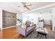 Open-concept living room featuring hardwood floors, neutral colors, stylish furniture, and access to the kitchen at 134 Turman Se Ave, Atlanta, GA 30315